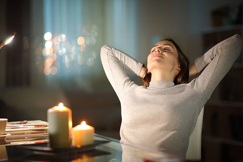 Menopausal woman relaxing with candles
